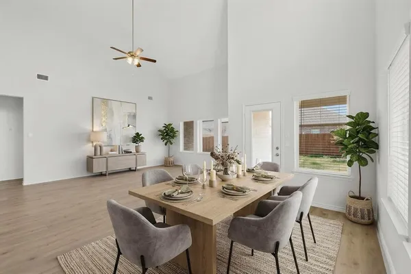 a view of a dining room with furniture and wooden floor