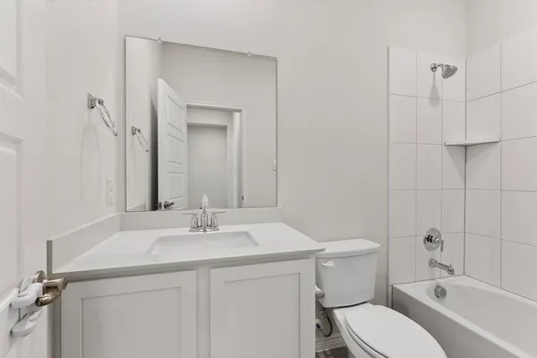 a bathroom with a sink vanity granite toilet and a mirror