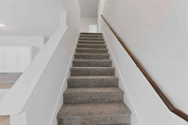 a view of staircase with white walls