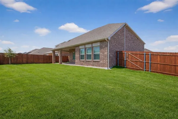 a view of a house with a yard and porch