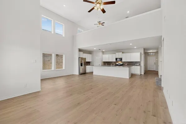 a view of a kitchen with a sink and a refrigerator