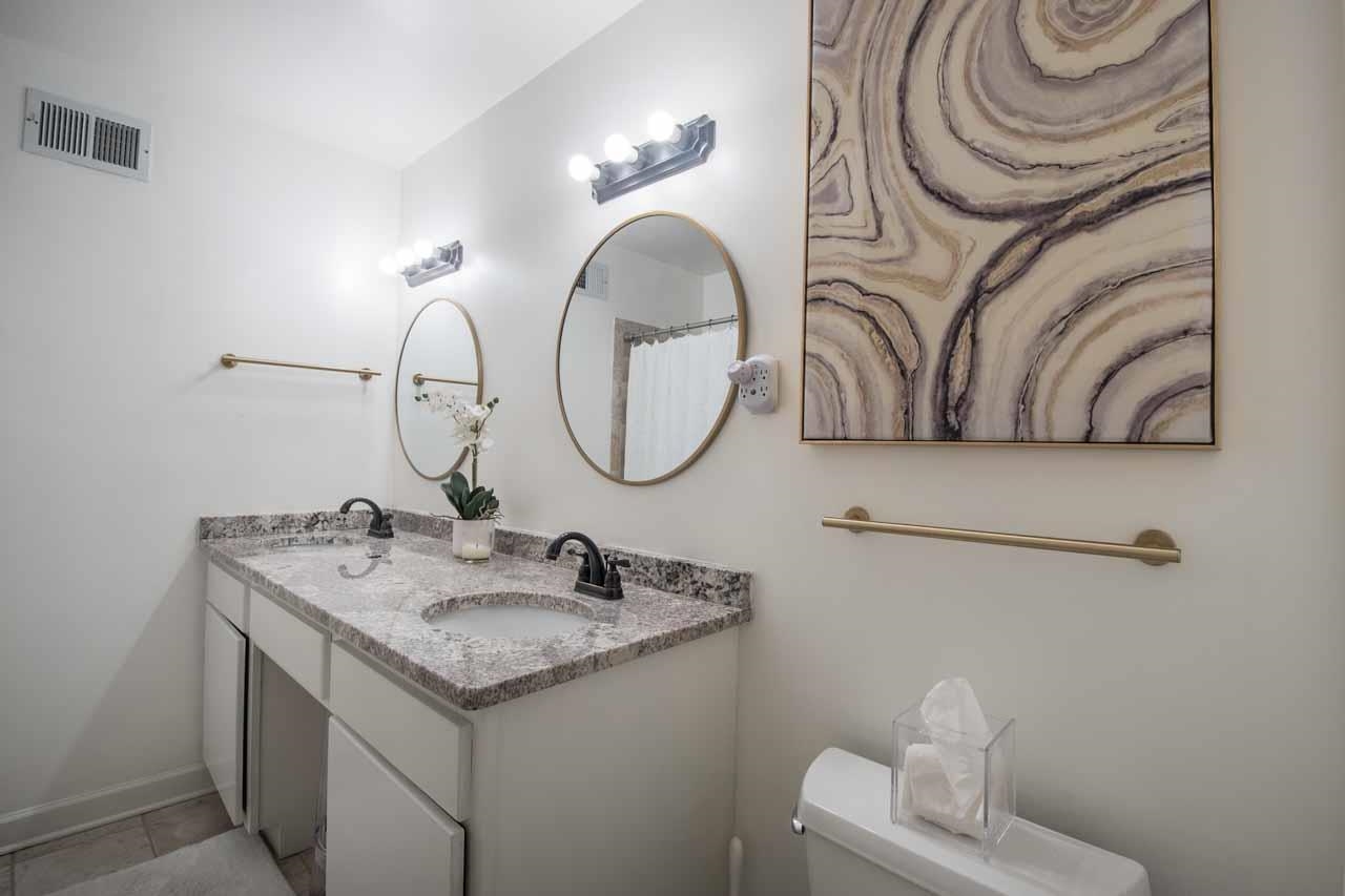 154 North Rose Road Memphis, TN 38117 - Photo 14 of 23 a bathroom with a sink and a mirror
