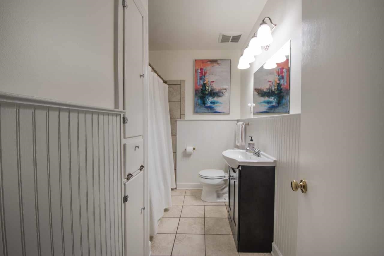 154 North Rose Road Memphis, TN 38117 - Photo 17 of 23 a bathroom with a sink and mirror with toilet