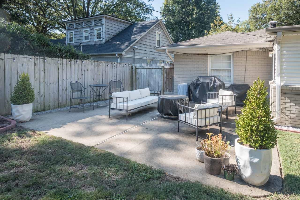 154 North Rose Road Memphis, TN 38117 - Photo 21 of 23 a view of a patio with couches chairs and wooden fence