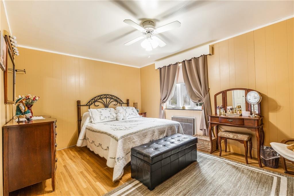 351 Goldsmith Road Pittsburgh, PA 15237 - Photo 15 of 25 a bedroom with a bed next to a large window with table and chairs
