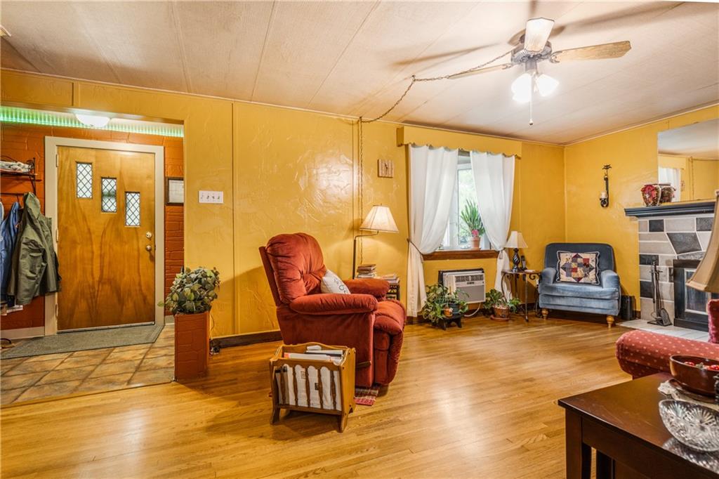 351 Goldsmith Road Pittsburgh, PA 15237 - Photo 4 of 25 a living room with furniture a fireplace and a chandelier