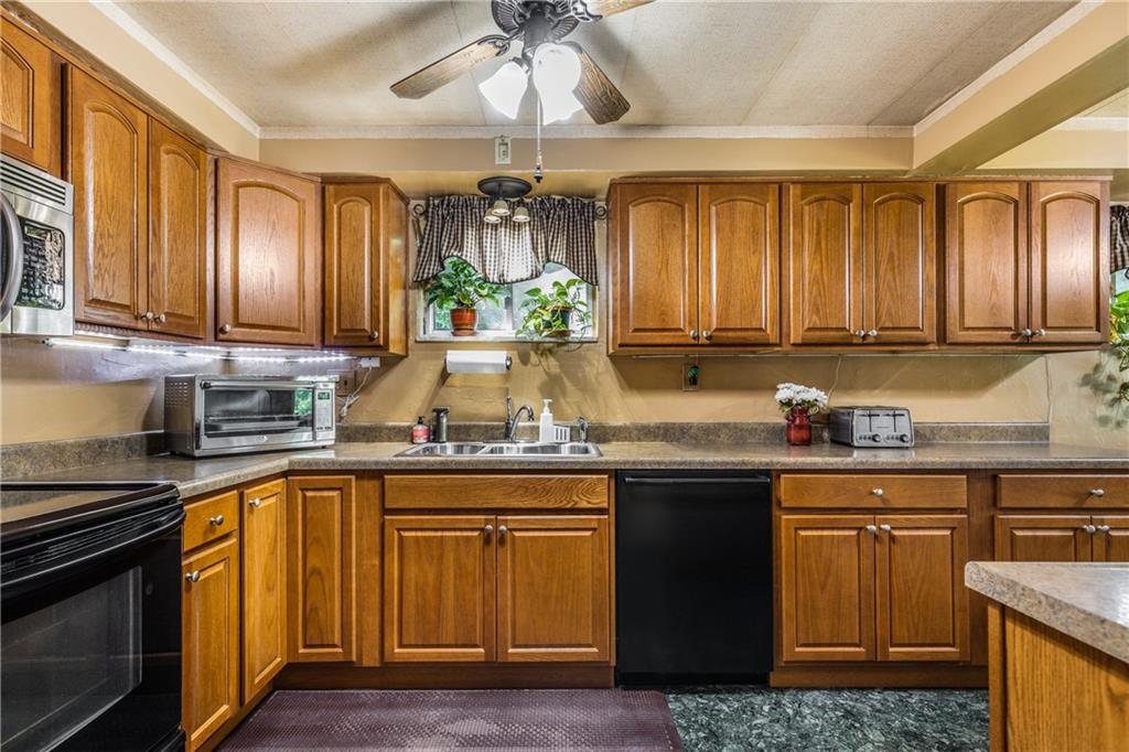 351 Goldsmith Road Pittsburgh, PA 15237 - Photo 9 of 25 a kitchen with stainless steel appliances granite countertop a stove a sink and a microwave