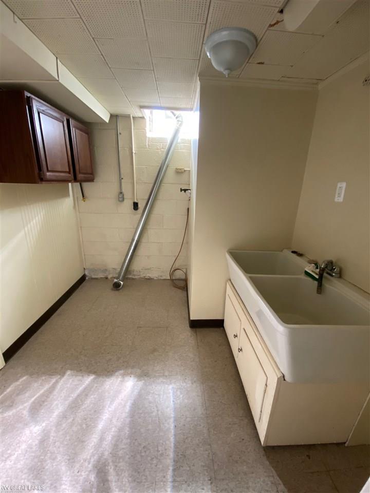597 Roslyn Road Grosse Pointe, MI 48236 - Photo 31 of 36 Basement laundry room with hook up for either gas or electric dryer and a nice big double porcelain sink