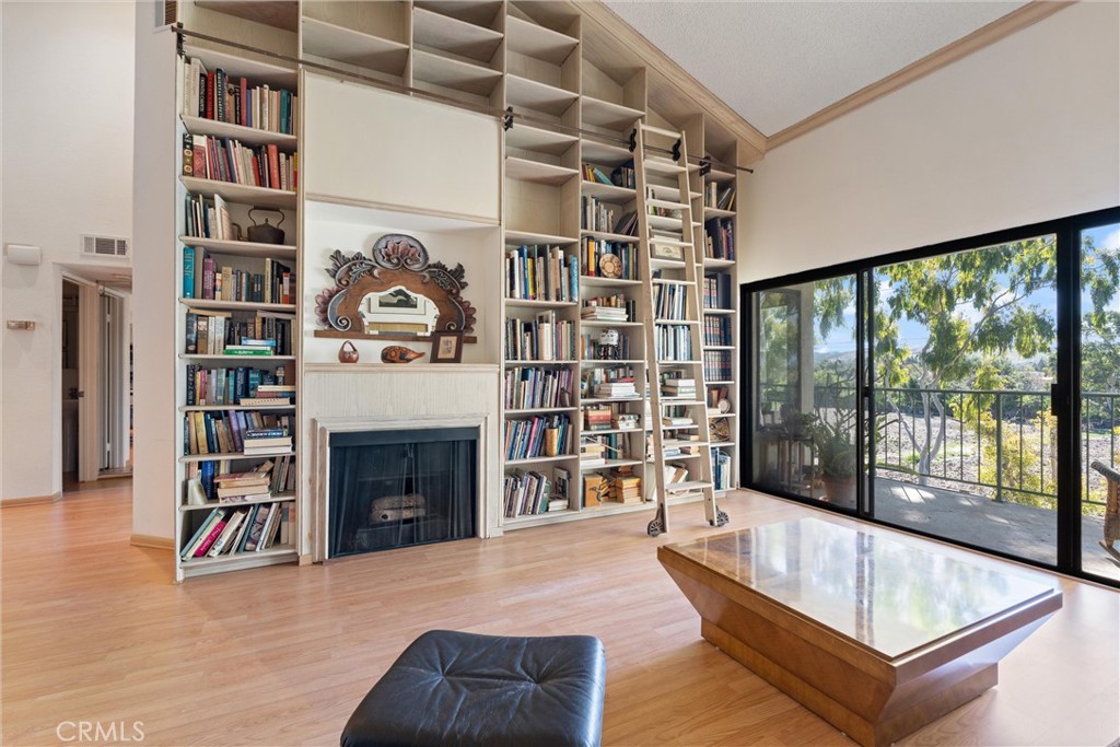 4311 Apricot Drive, Unit 4311 Irvine, CA 92618 - Photo 1 of 17 a living room with a large window and a fireplace
