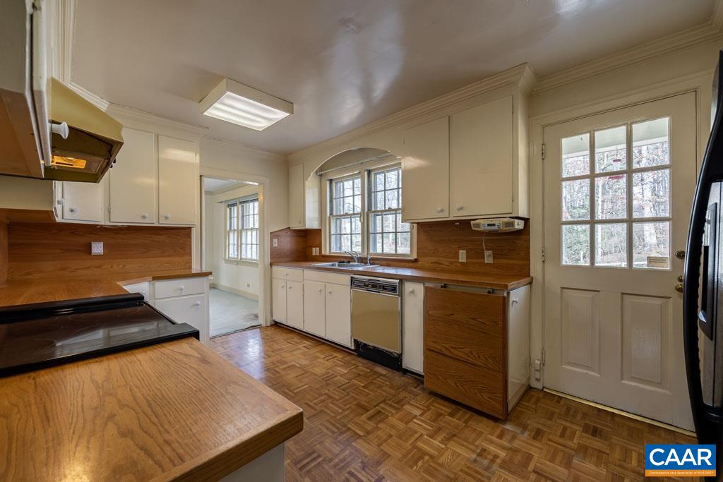 1644 St Annes Road Charlottesville, VA 22901 - Photo 16 of 58 a kitchen with granite countertop a stove a sink and a microwave