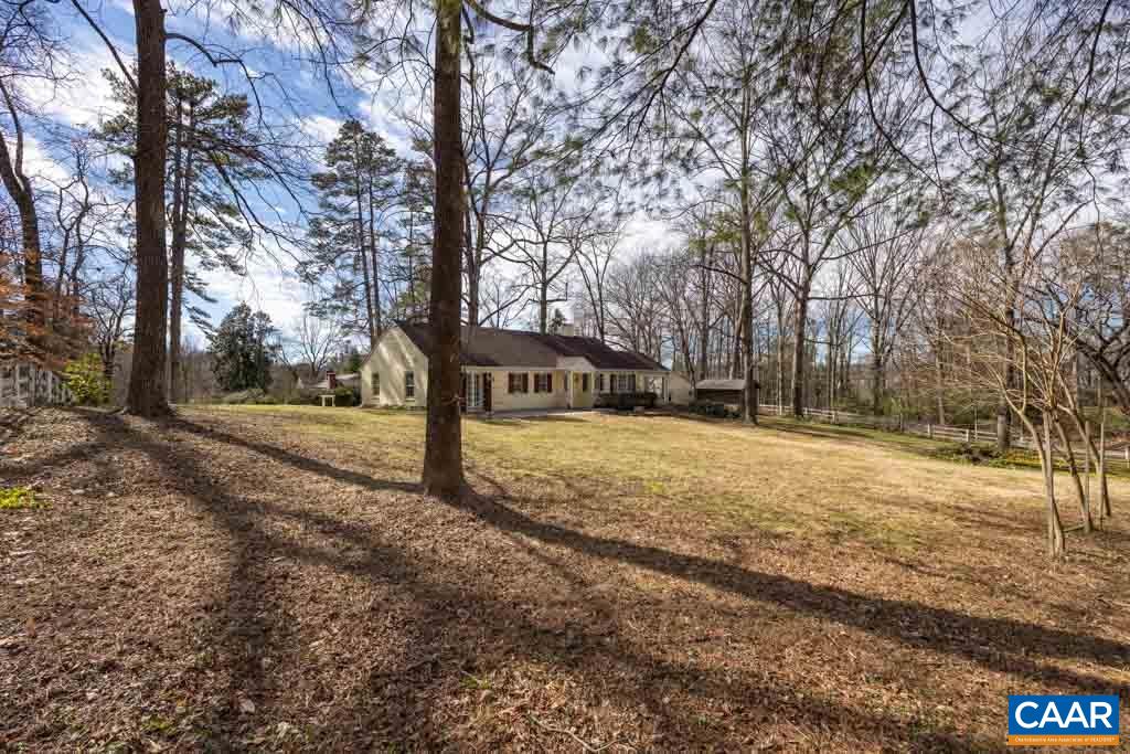 1644 St Annes Road Charlottesville, VA 22901 - Photo 44 of 58 a street view with large trees