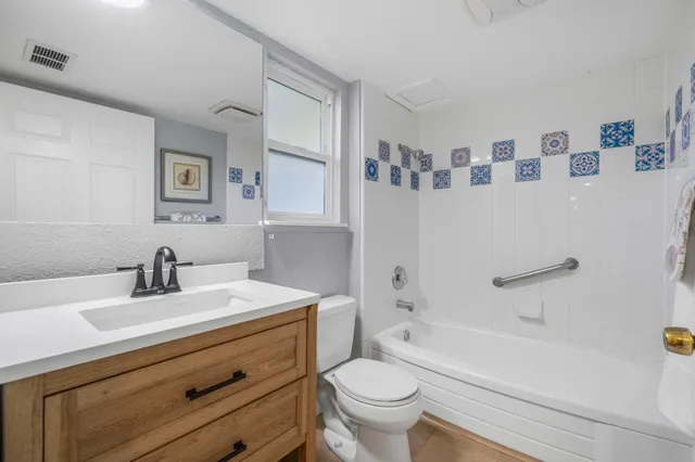 a bathroom with a sink a toilet and a bathtub