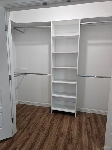 a view of walk in closet with empty racks
