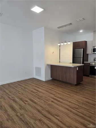 a view of kitchen with wooden floor