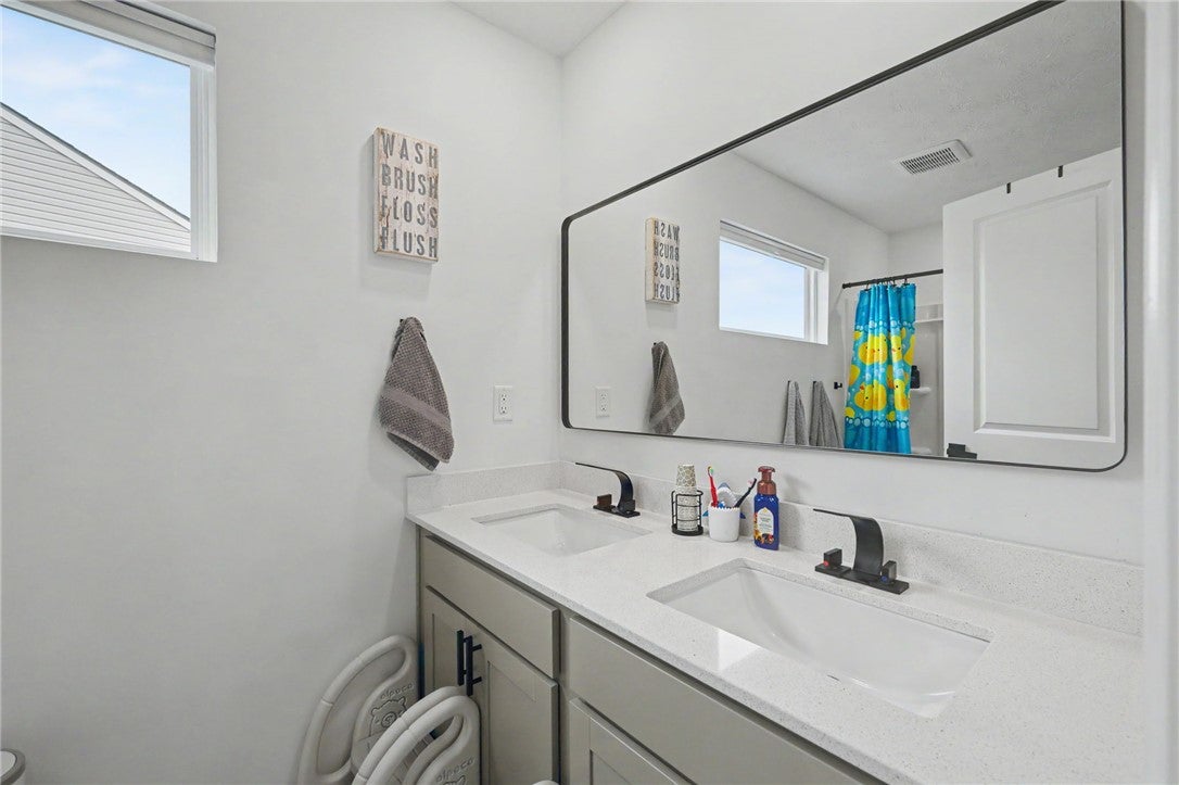 3011 Falls Road Clayton, OH 45315 - Photo 50 of 66 Dual vanity with pristine countertops and a stylish mirror complete this bright, well-appointed bathroom.