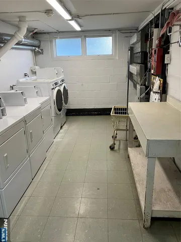 a view of a storage & utility room with two washing machine