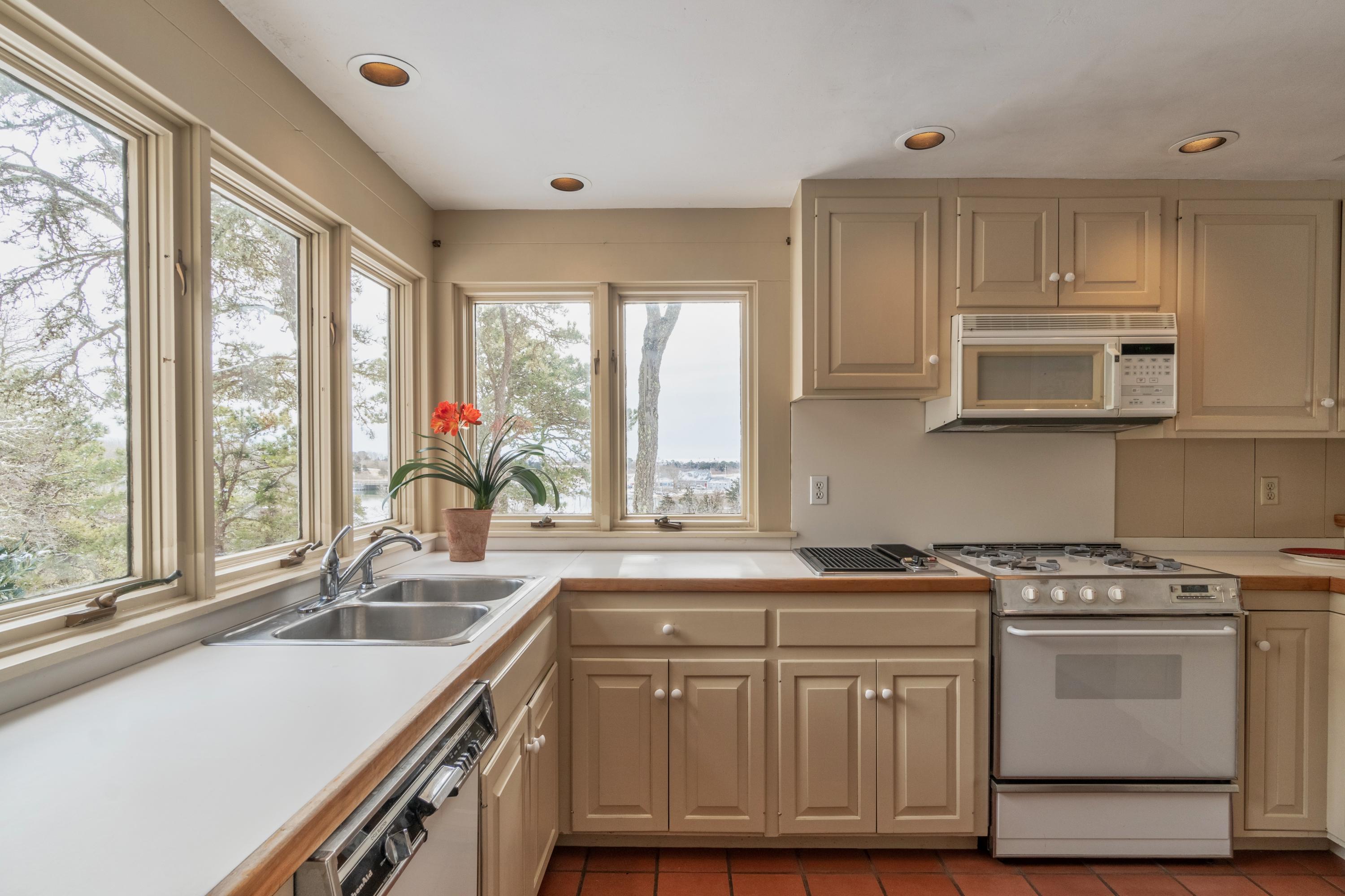 70 Inlet Road Chatham, MA 02633 - Photo 11 of 35 a kitchen with granite countertop a sink a counter space appliances and cabinets