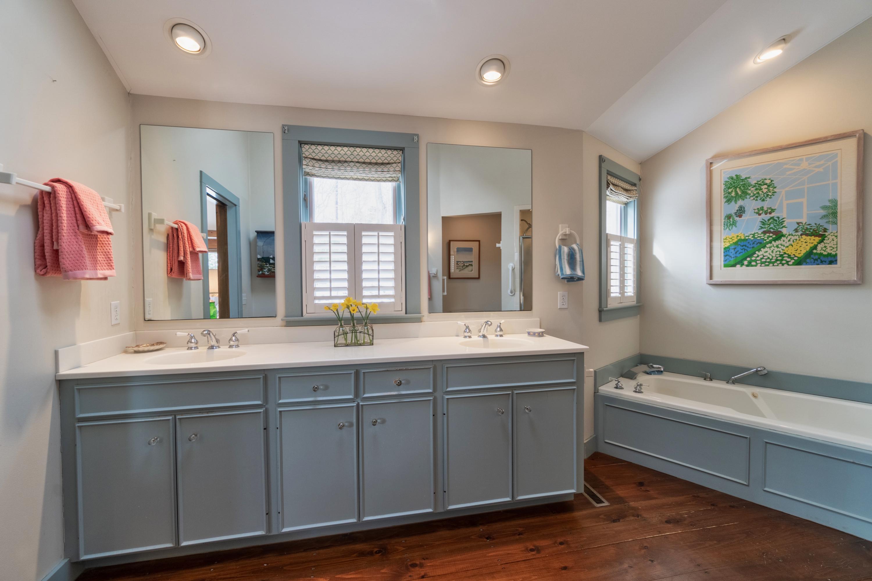 70 Inlet Road Chatham, MA 02633 - Photo 17 of 35 a spacious bathroom with a granite countertop sink and mirror with bathtub