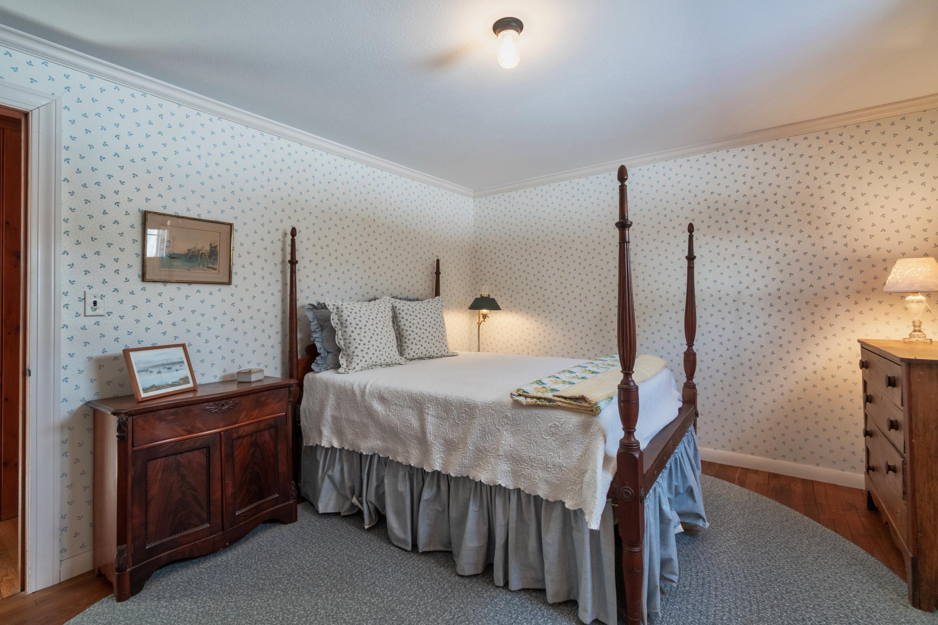 70 Inlet Road Chatham, MA 02633 - Photo 19 of 35 a bedroom with a bed a lamp and a flat screen tv