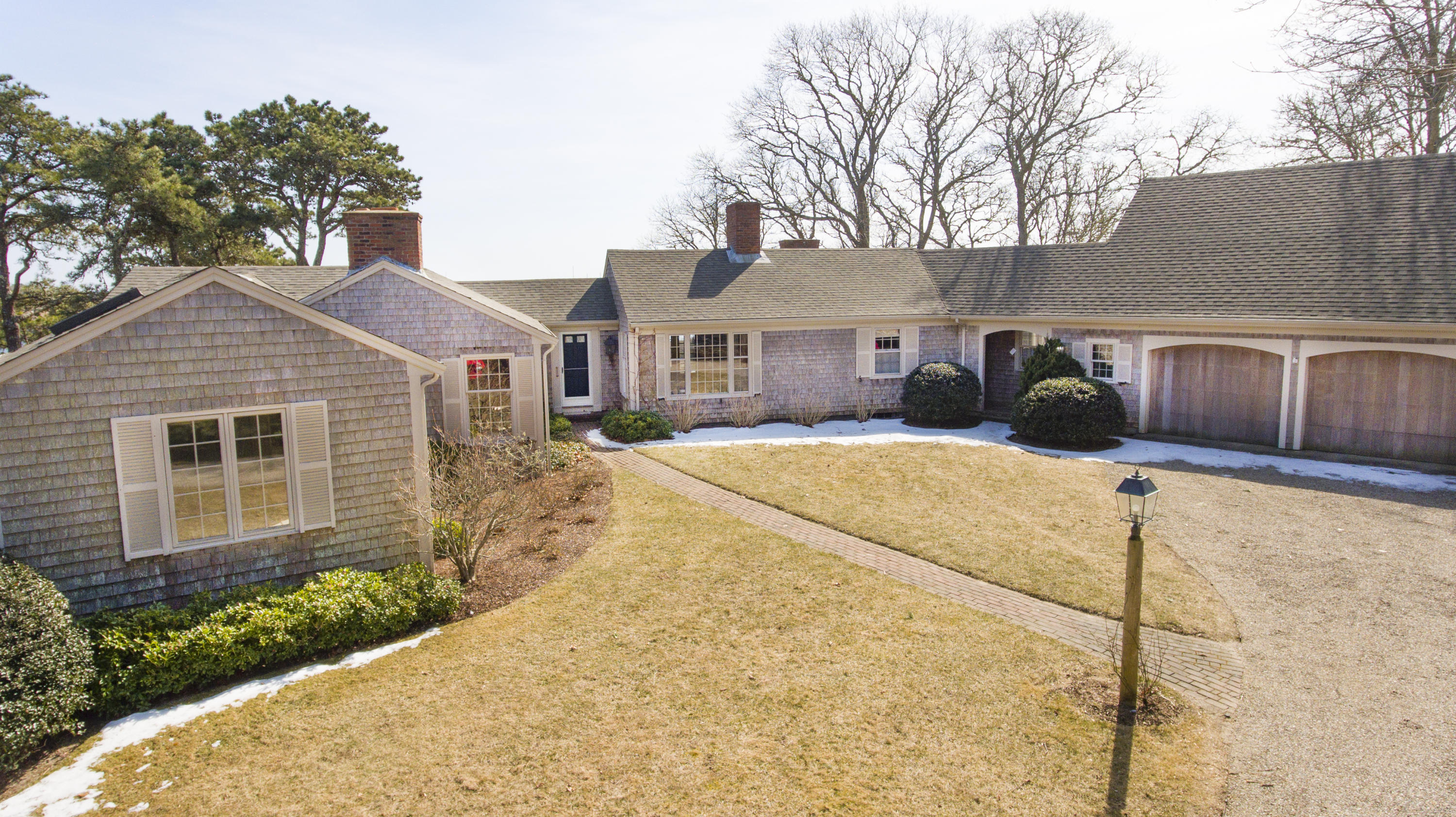70 Inlet Road Chatham, MA 02633 - Photo 4 of 35 a front view of a house with a yard and garage