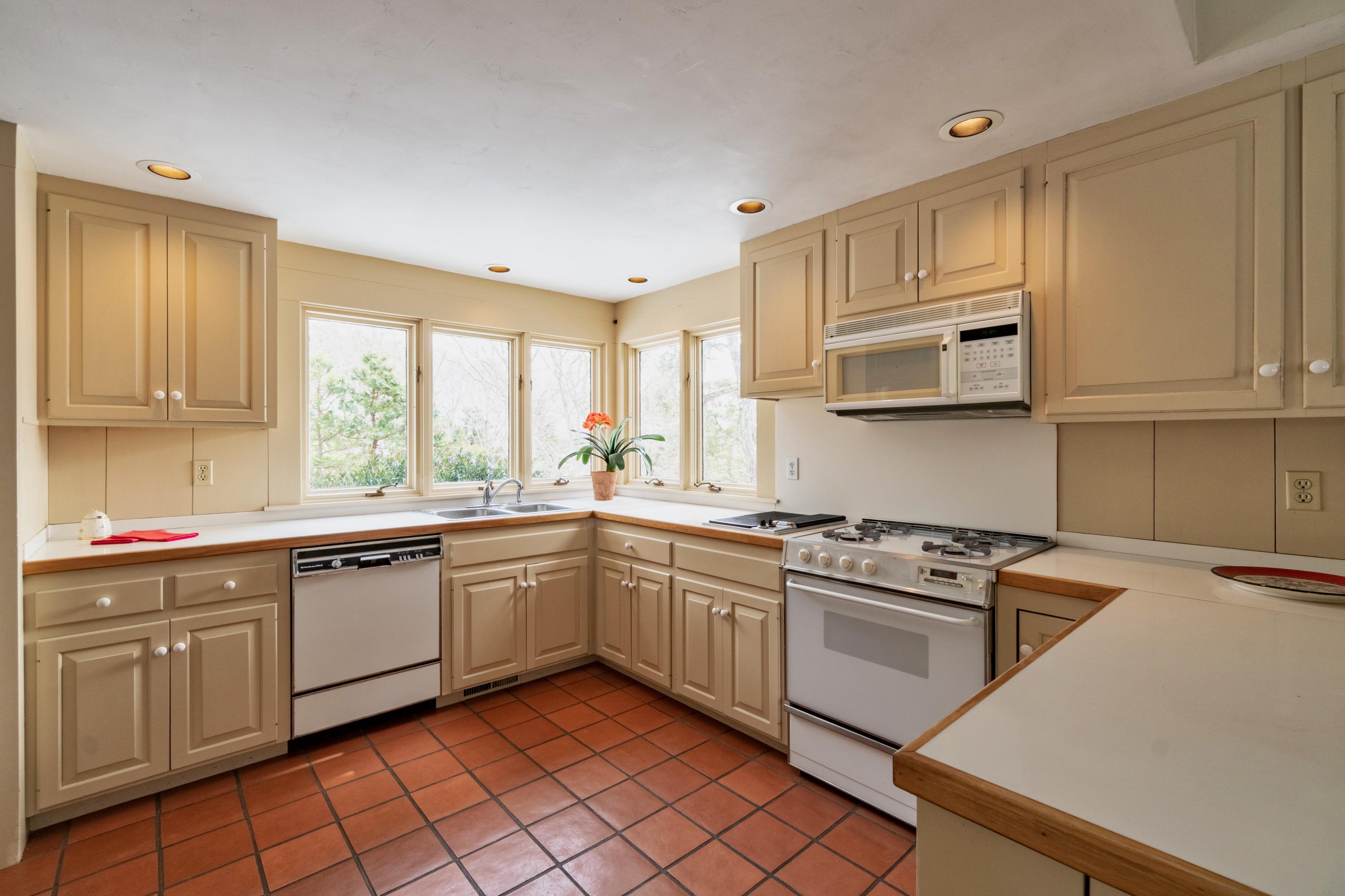 70 Inlet Road Chatham, MA 02633 - Photo 10 of 35 a kitchen with stainless steel appliances granite countertop a stove sink and cabinets