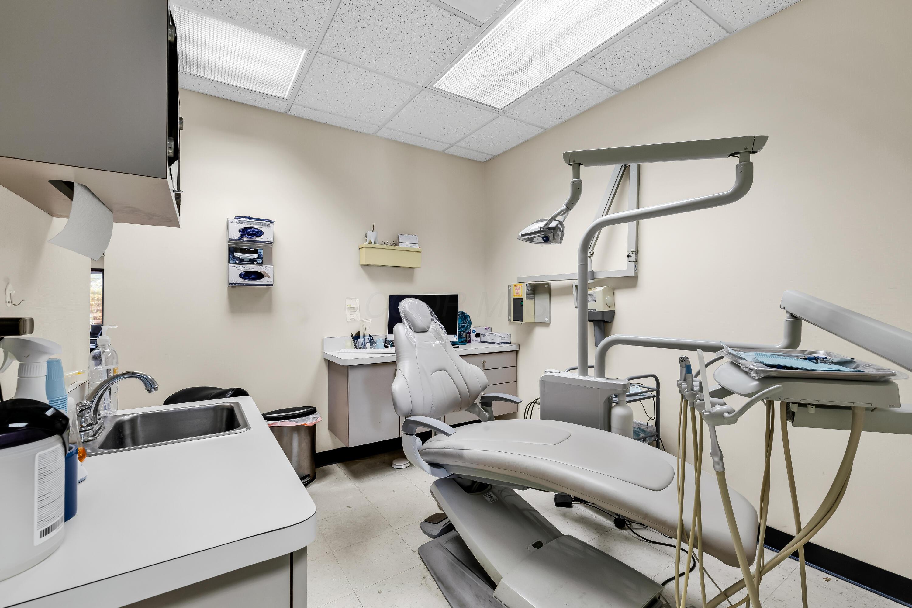 1240 Crescent Heights Road Marion, OH 43302 - Photo 44 of 60 • Neutral vinyl flooring • Ivory painted walls • Acoustic ceiling tiles • Fluorescent lighting • Vanity with single bowl, stainless steel sinktop