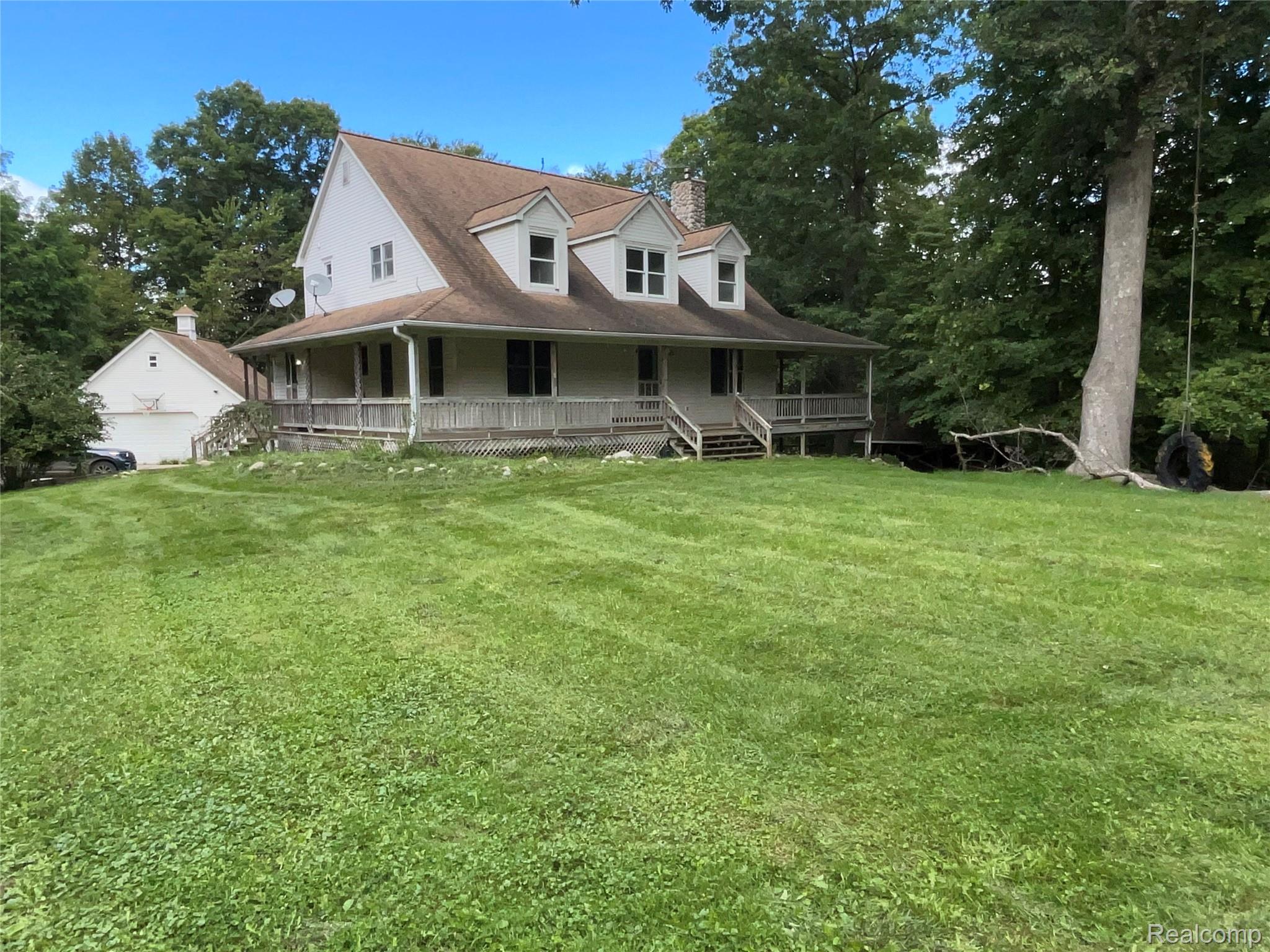 3425 East Sutton Road Dryden, MI 48428 - Photo 74 of 74 Country-style home with a chimney, a porch, and a front yard