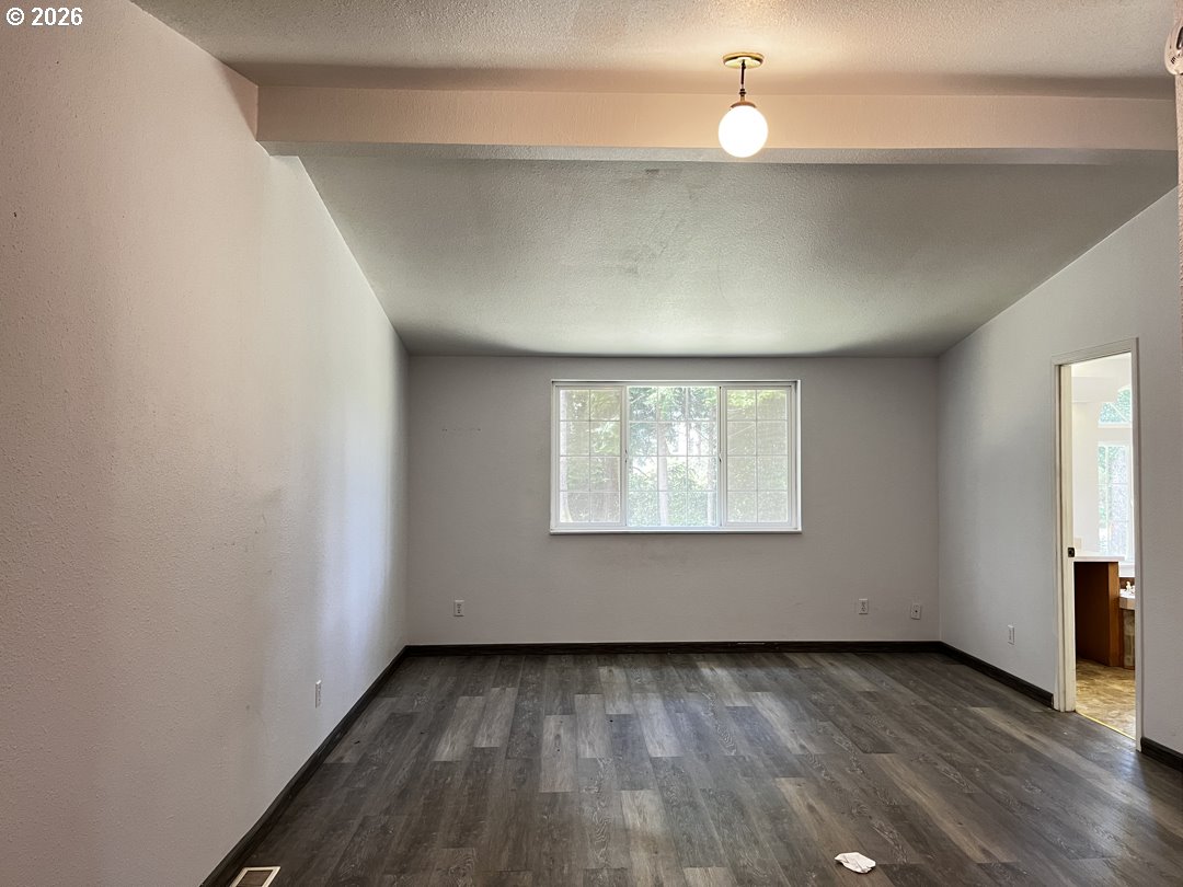83411 Clear Lake Road Florence, OR 97439 - Photo 27 of 47 an empty room with wooden floor fan and windows