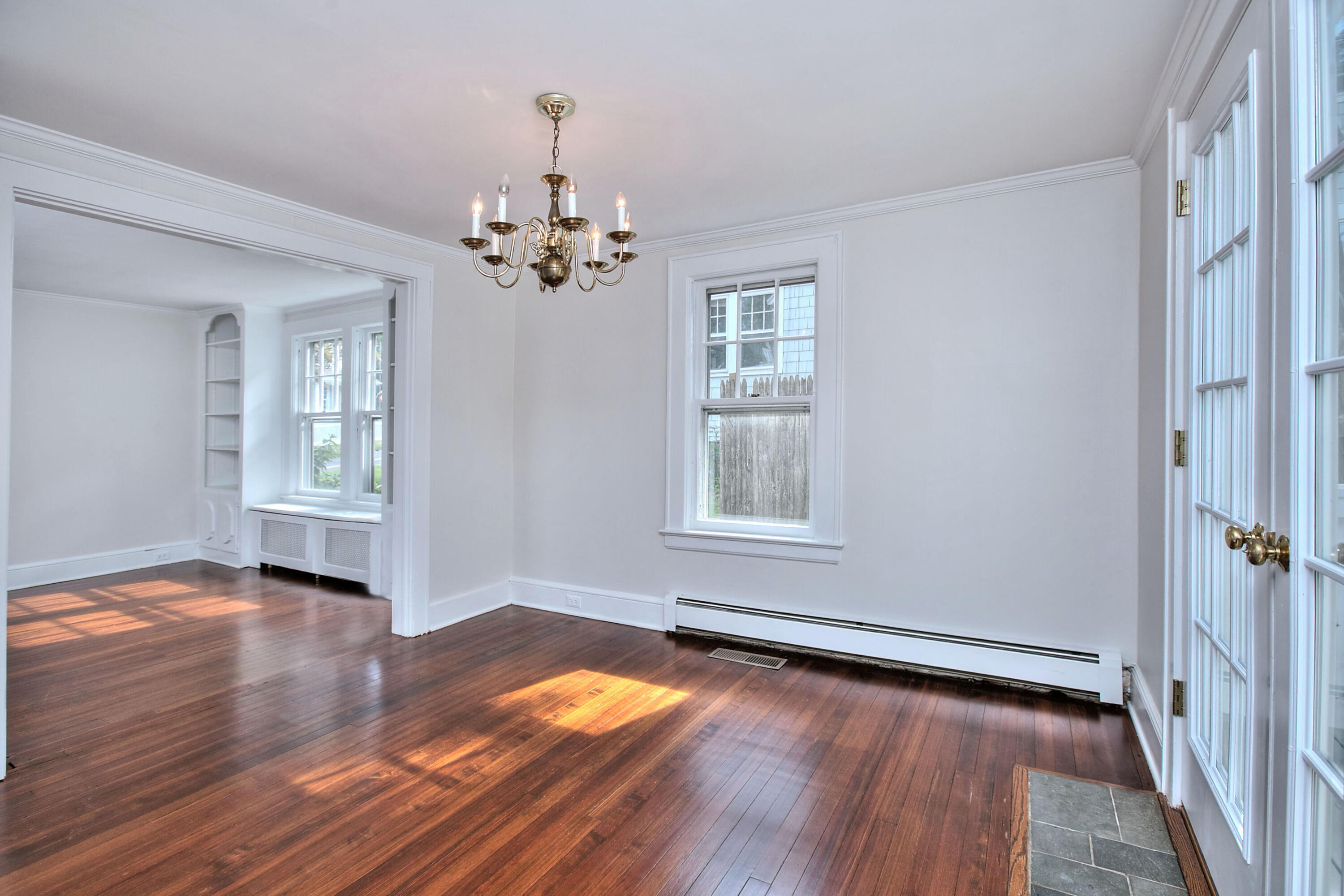 89 Richmond Hill Road New Canaan, CT 06840 - Photo 11 of 40 an empty room with wooden floor and windows