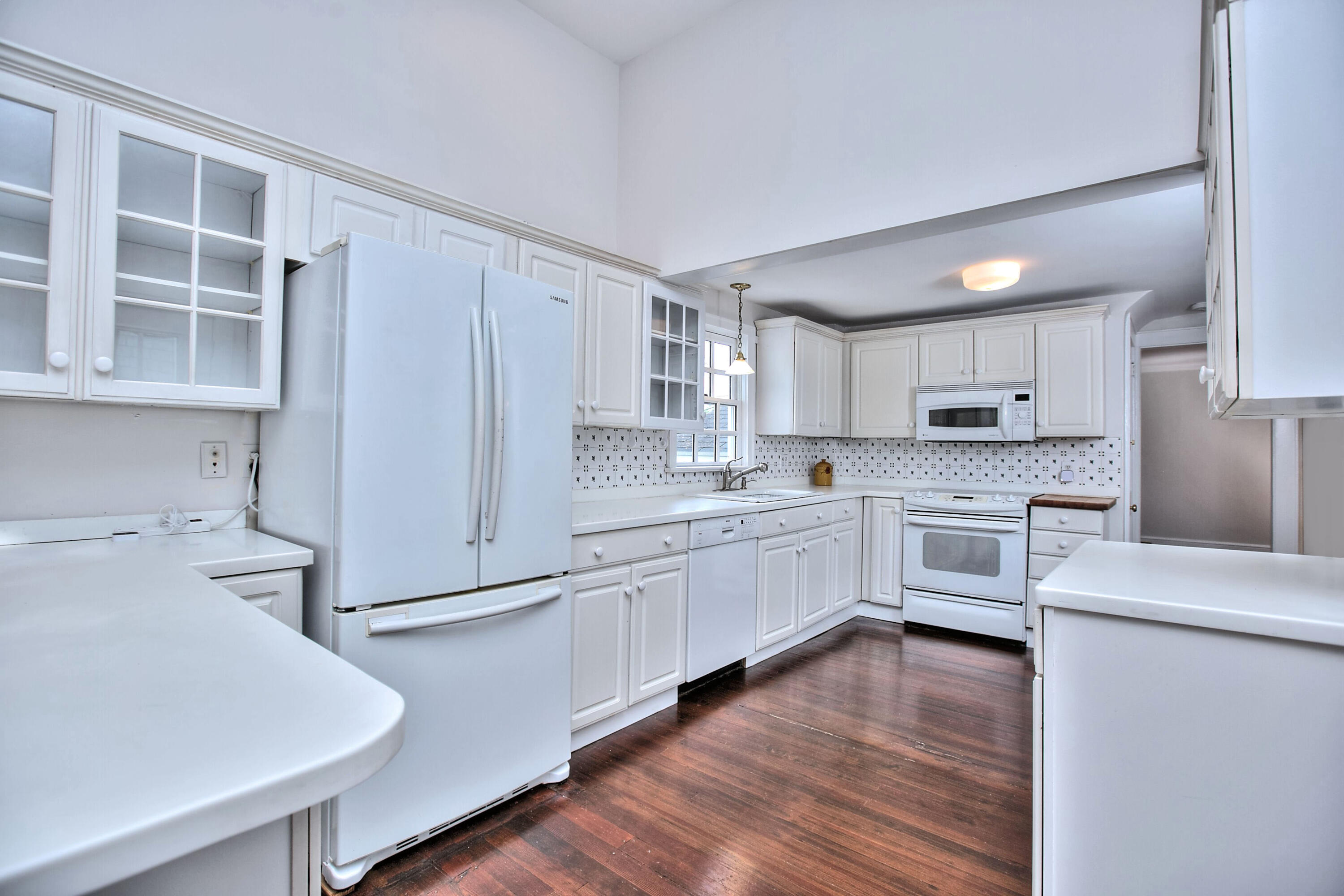89 Richmond Hill Road New Canaan, CT 06840 - Photo 13 of 40 a kitchen with granite countertop white cabinets and white appliances