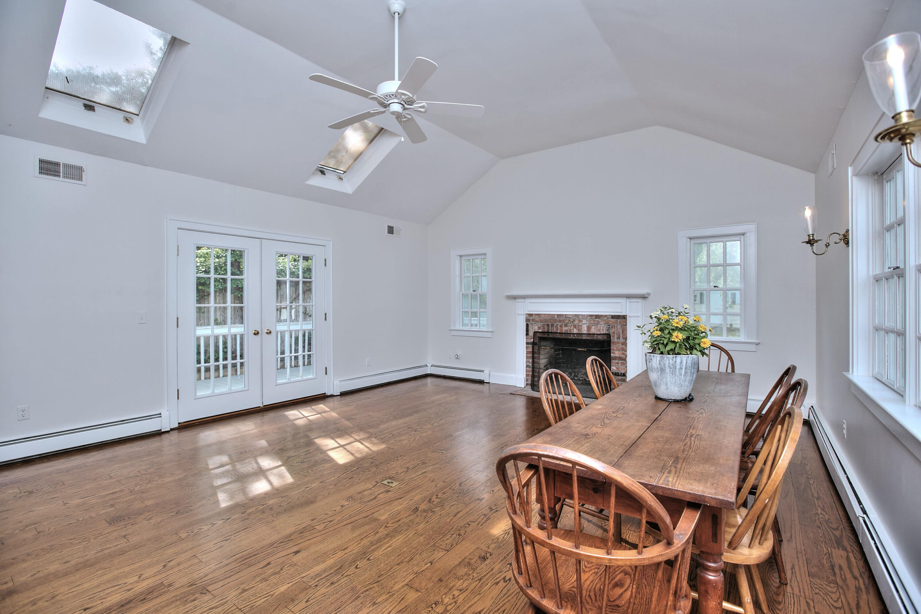 89 Richmond Hill Road New Canaan, CT 06840 - Photo 17 of 40 a view of a livingroom with furniture a fireplace wooden floor and chandelier