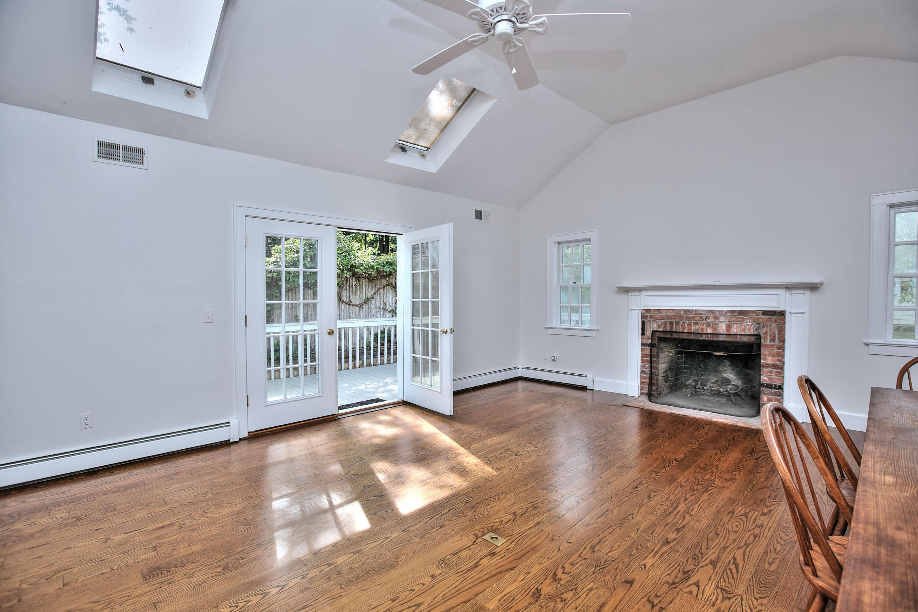89 Richmond Hill Road New Canaan, CT 06840 - Photo 18 of 40 wooden floor fireplace and windows in an empty room