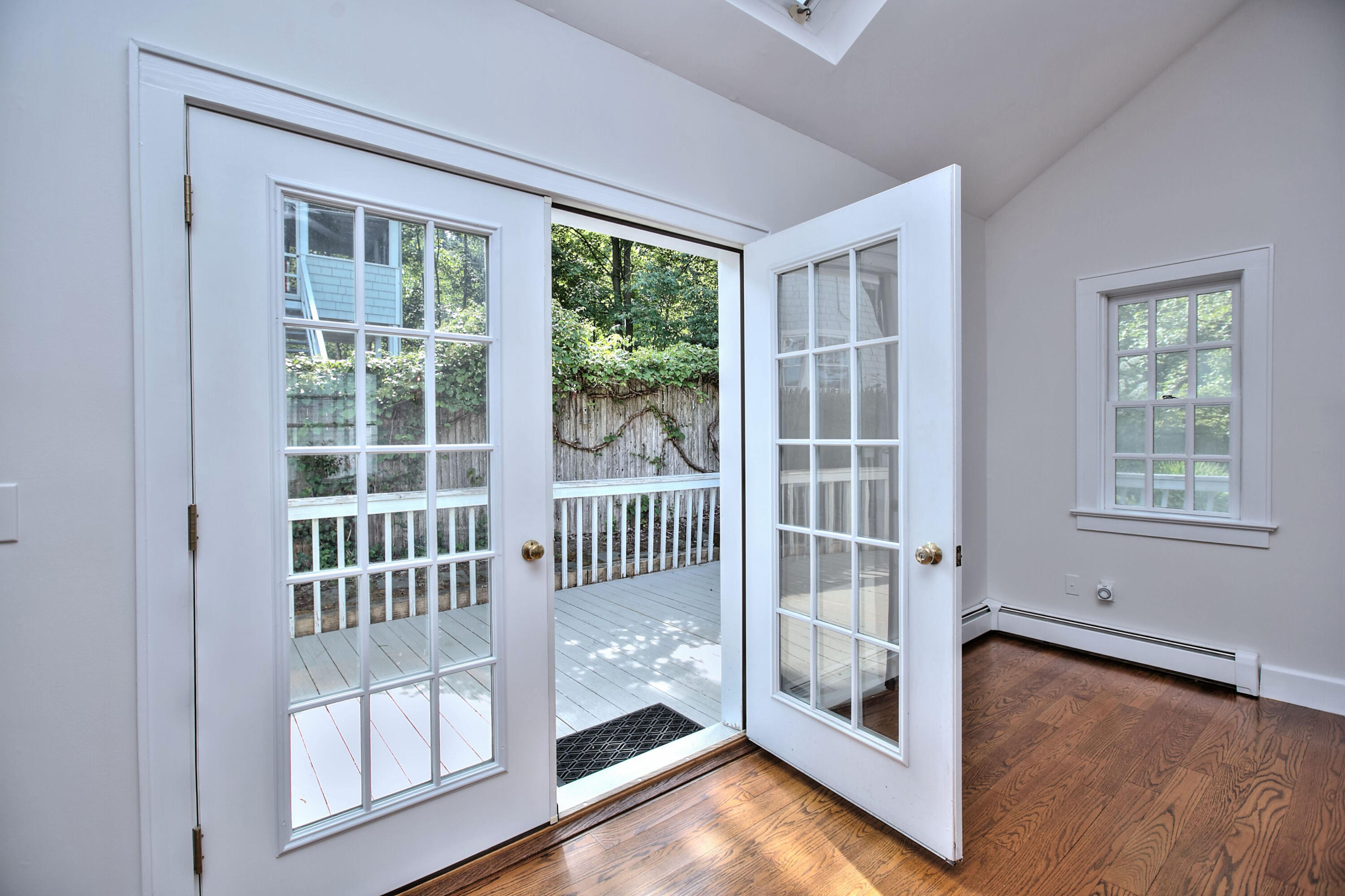 89 Richmond Hill Road New Canaan, CT 06840 - Photo 20 of 40 a view of an empty room with wooden floor and a window