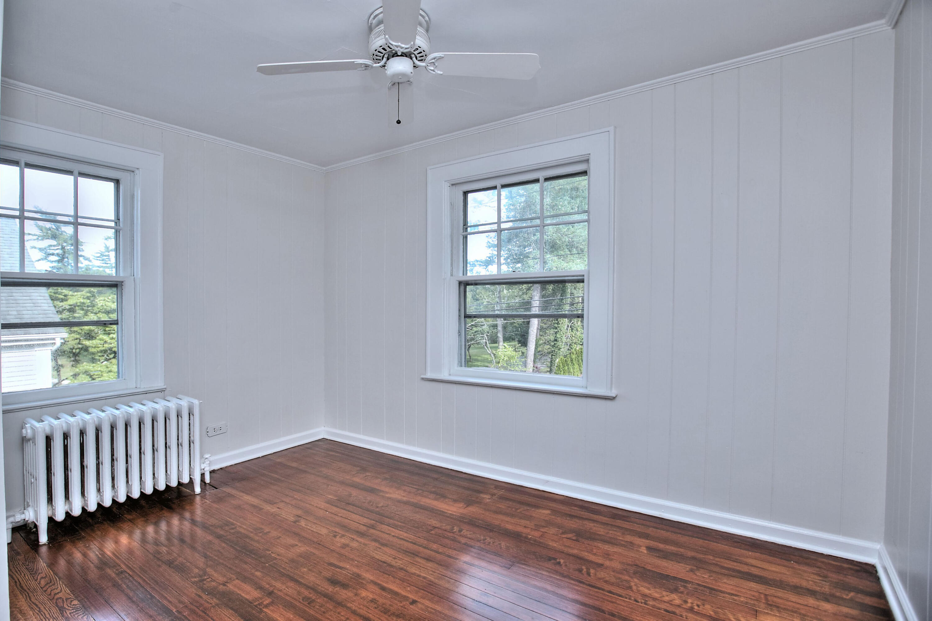 89 Richmond Hill Road New Canaan, CT 06840 - Photo 24 of 40 a view of an empty room with wooden floor and a window