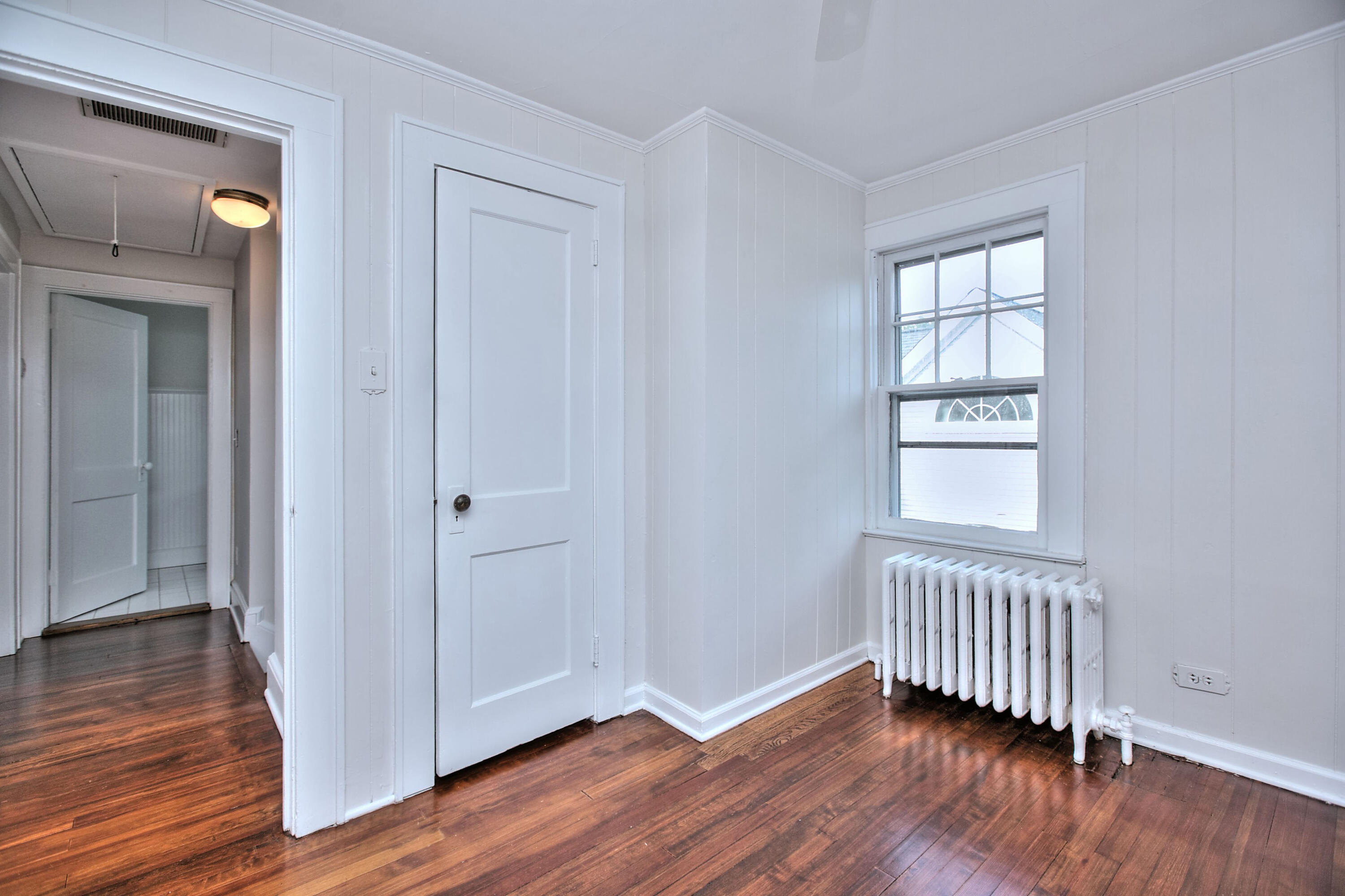89 Richmond Hill Road New Canaan, CT 06840 - Photo 25 of 40 a view of an empty room with wooden floor and a window