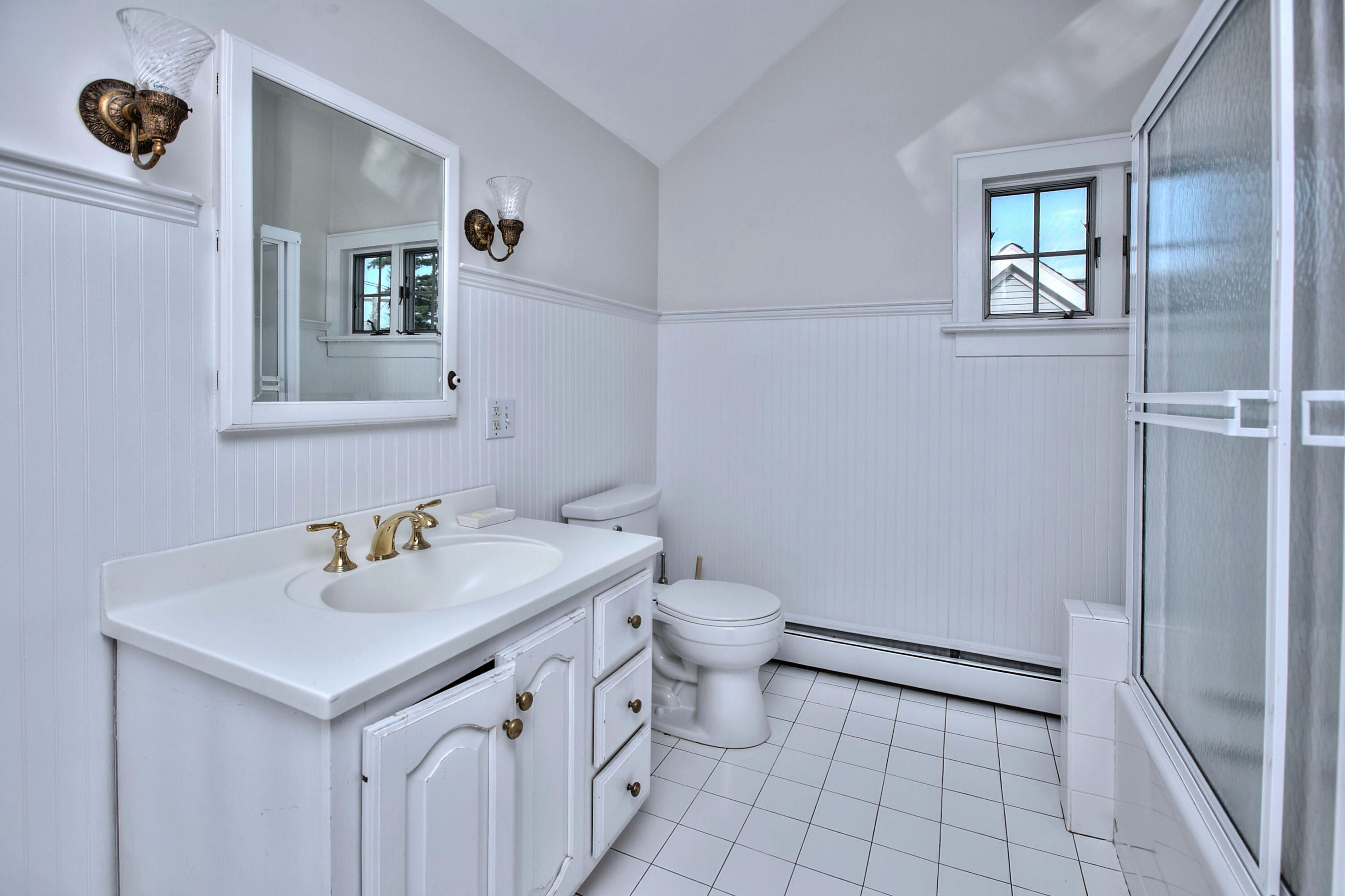 89 Richmond Hill Road New Canaan, CT 06840 - Photo 28 of 40 a bathroom with a sink toilet and mirror