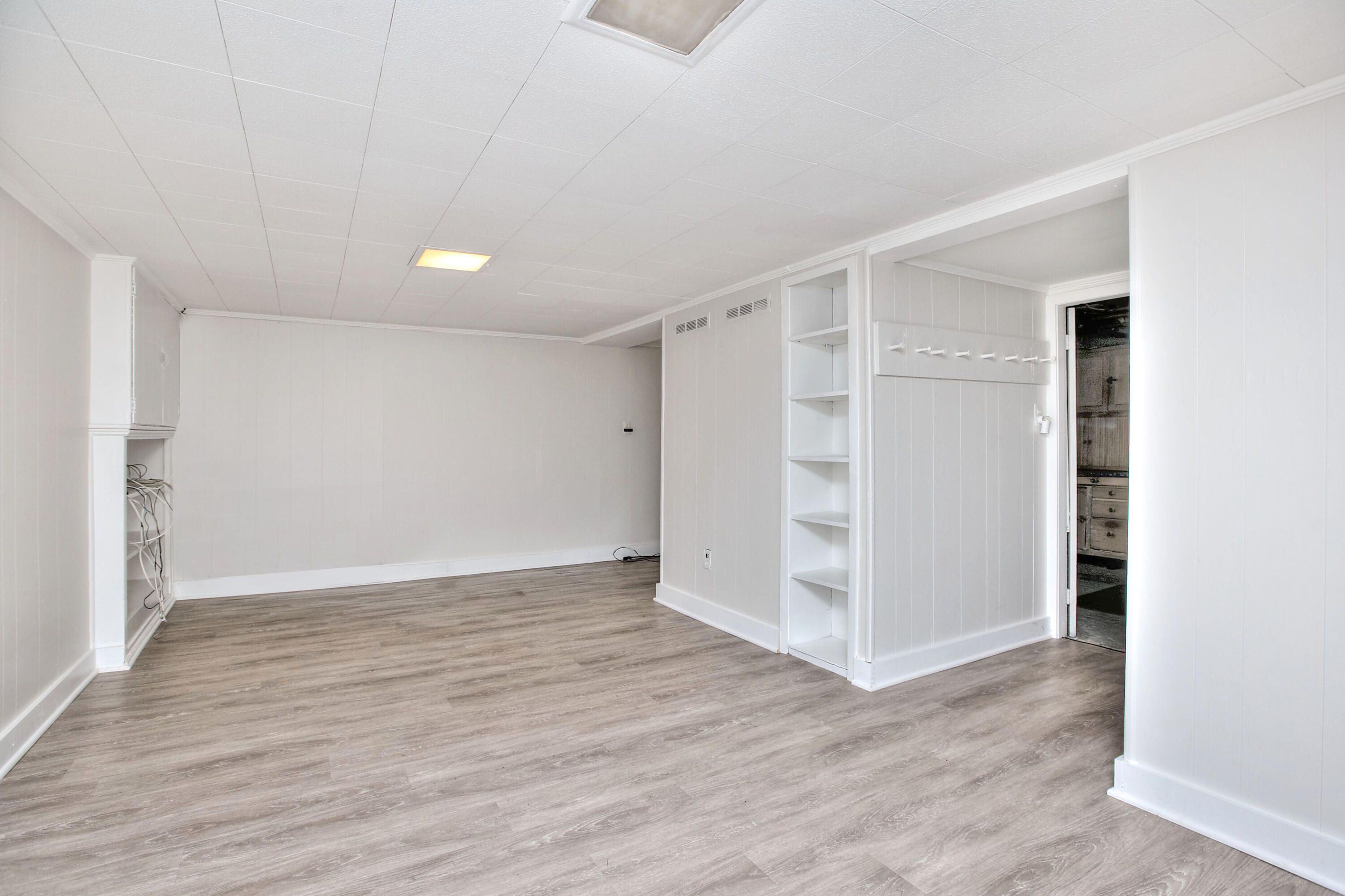 89 Richmond Hill Road New Canaan, CT 06840 - Photo 29 of 40 a view of an empty room with wooden floor