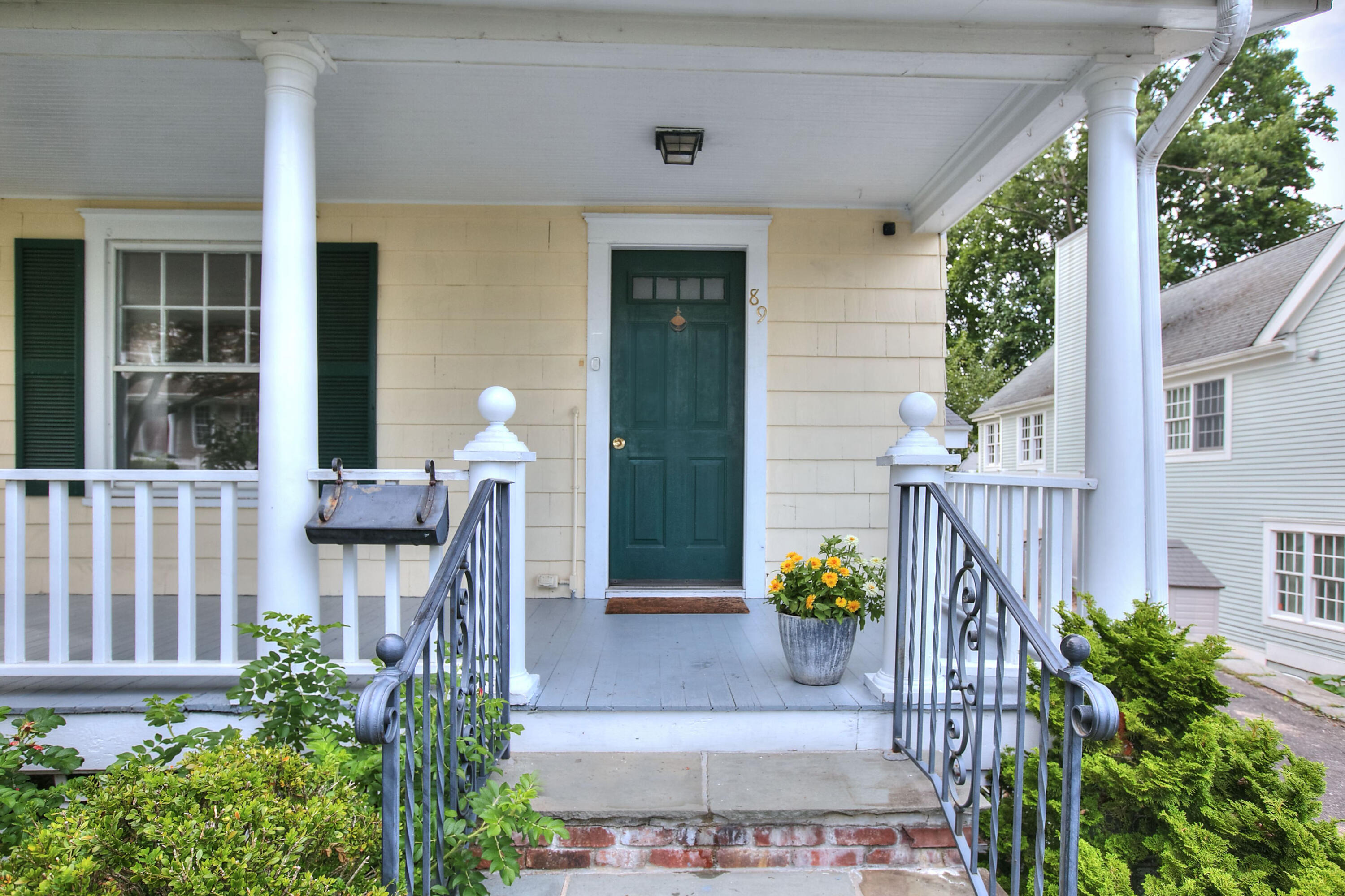89 Richmond Hill Road New Canaan, CT 06840 - Photo 30 of 40 a front view of a house with outdoor seating and plants