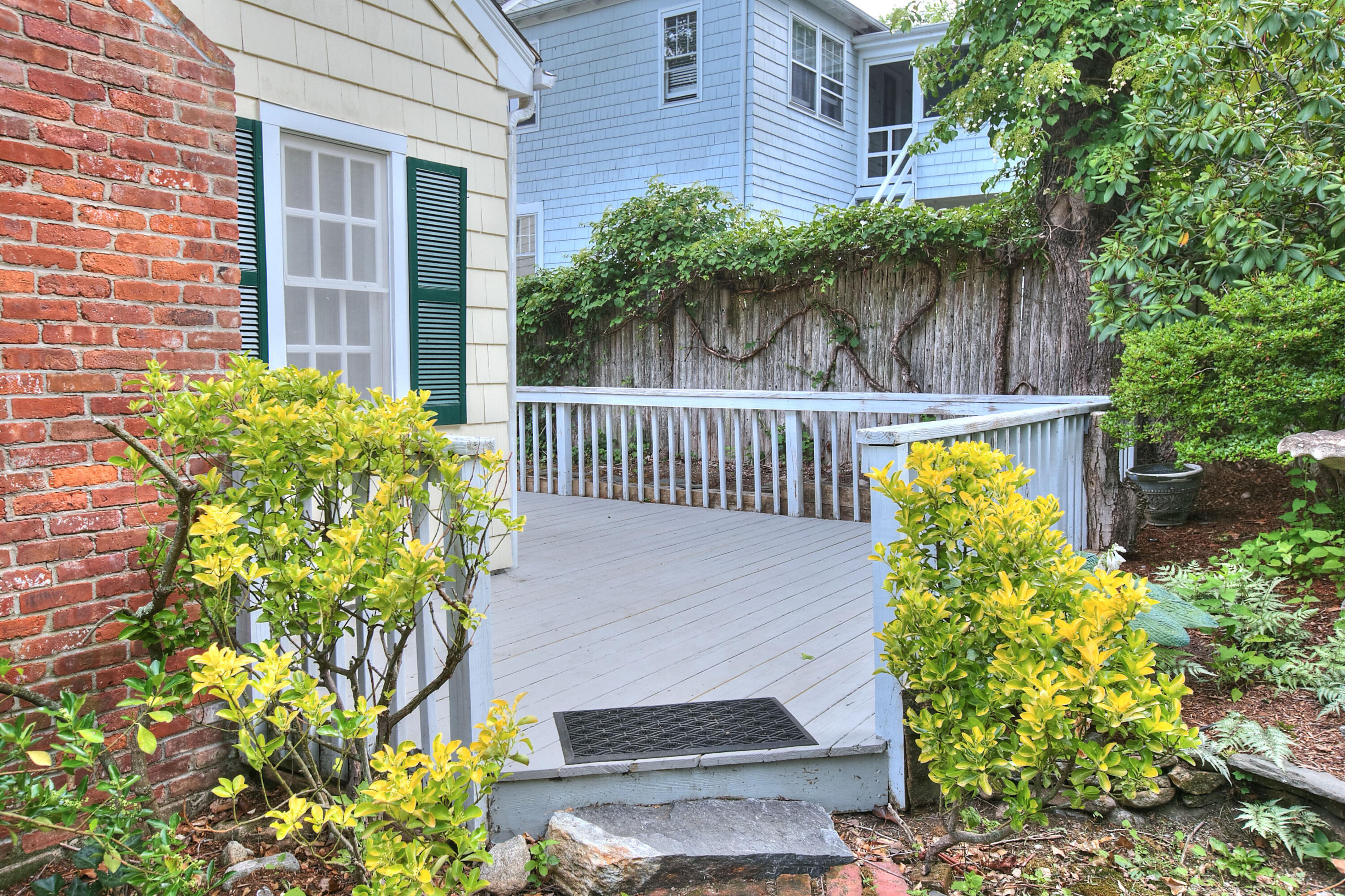89 Richmond Hill Road New Canaan, CT 06840 - Photo 35 of 40 a view of a house with a small yard and flower plants