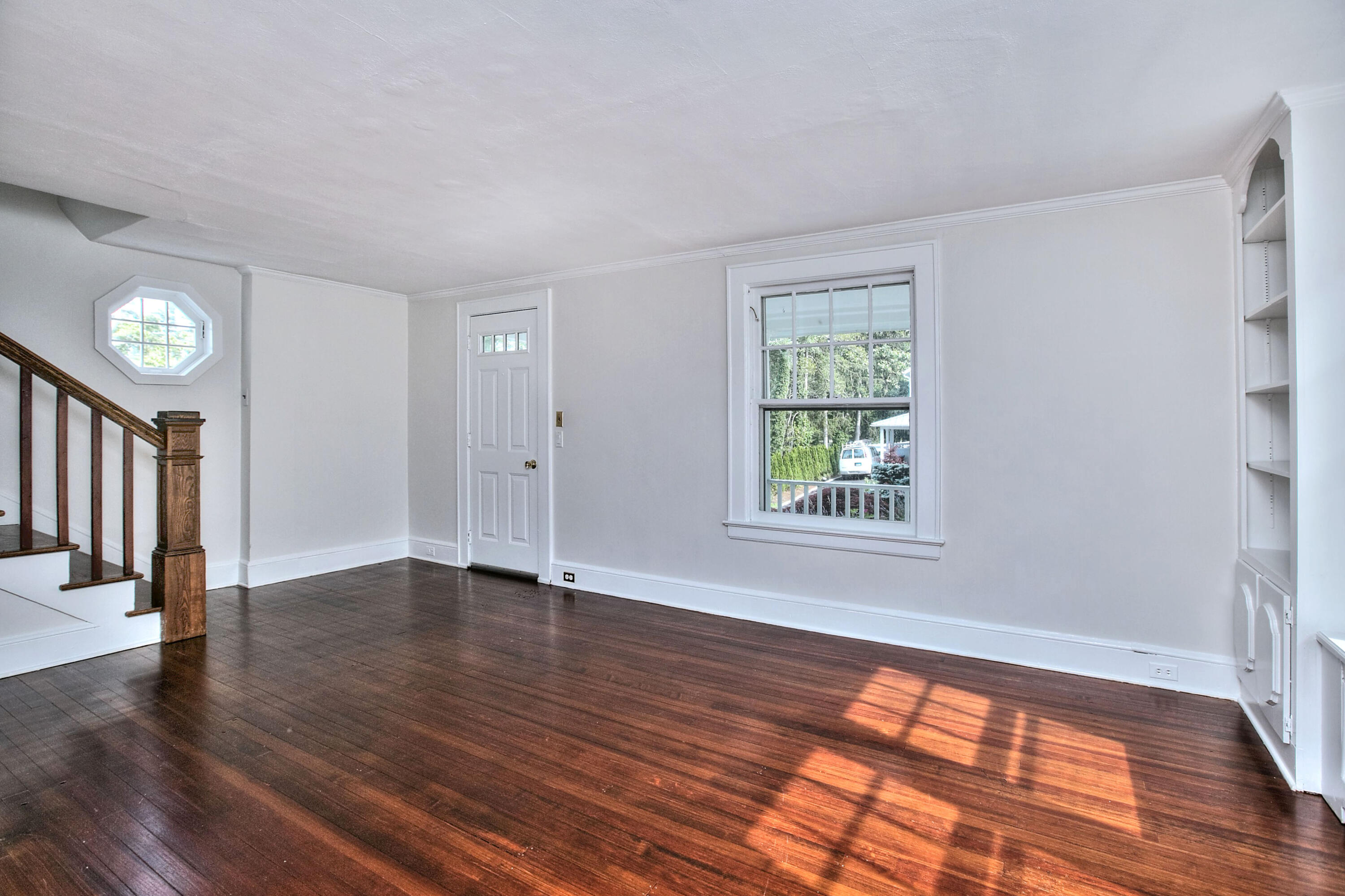 89 Richmond Hill Road New Canaan, CT 06840 - Photo 6 of 40 a view of an empty room with wooden floor and a window