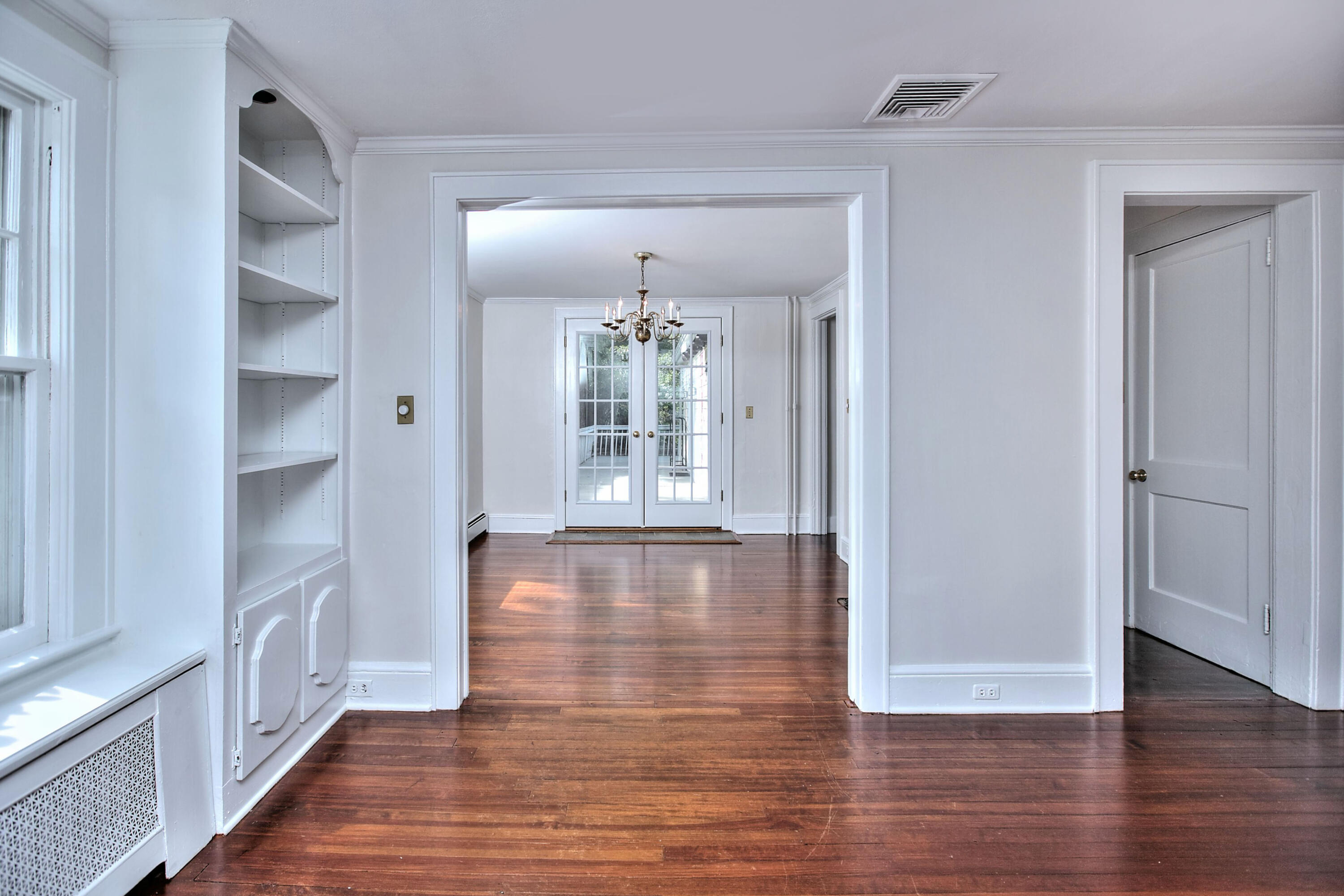 89 Richmond Hill Road New Canaan, CT 06840 - Photo 8 of 40 an empty room with wooden floor and windows