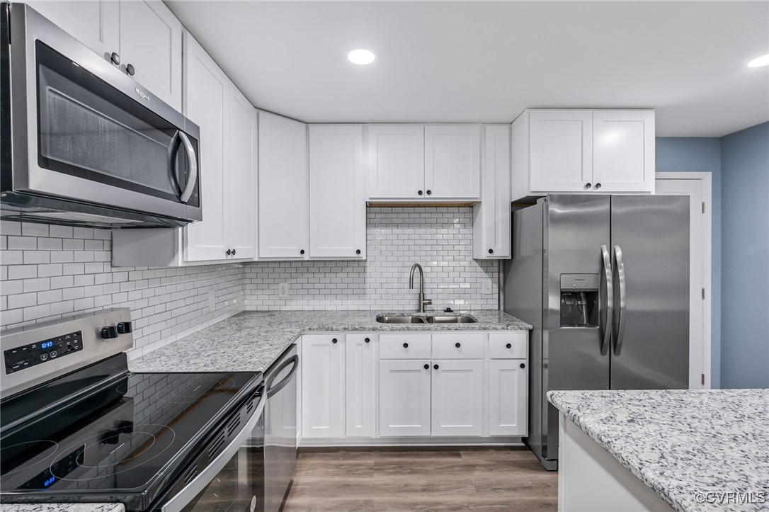 9232 Groomfield Road Chesterfield, VA 23236 - Photo 12 of 50 a kitchen with kitchen island granite countertop a sink stove and refrigerator