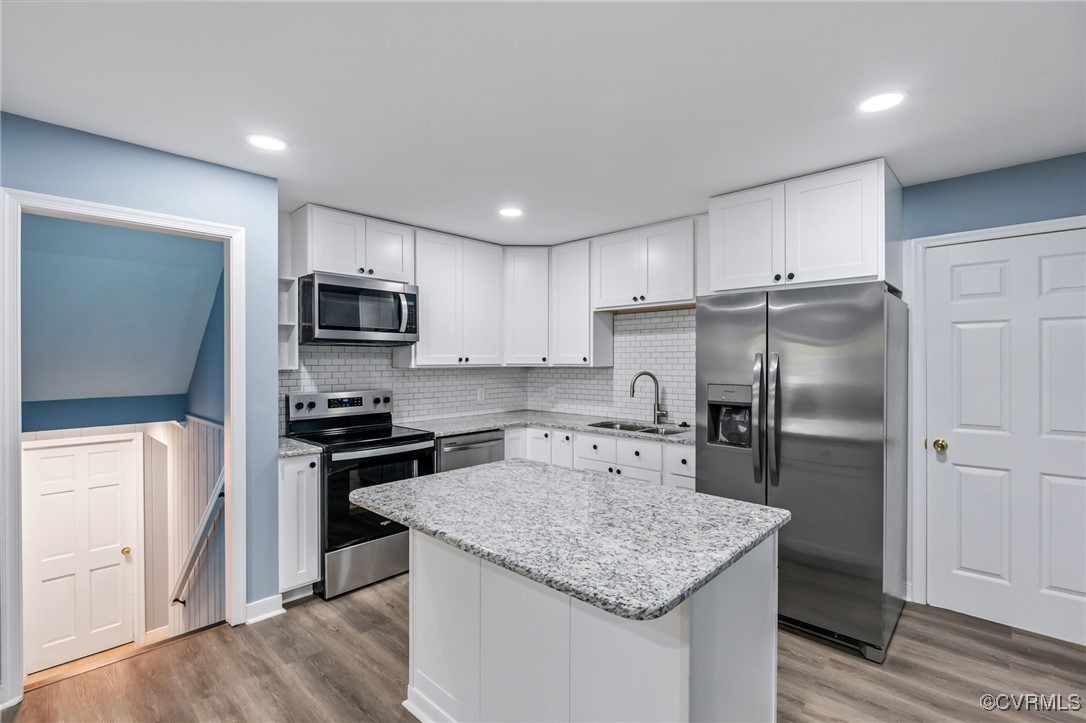 9232 Groomfield Road Chesterfield, VA 23236 - Photo 13 of 50 a kitchen with a refrigerator a sink a stove a microwave and wooden floor
