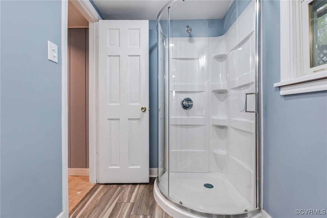 9232 Groomfield Road Chesterfield, VA 23236 - Photo 19 of 50 a bathroom with a glass shower door