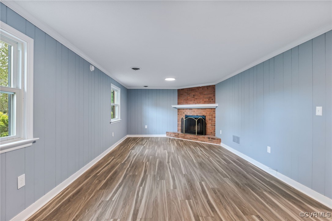9232 Groomfield Road Chesterfield, VA 23236 - Photo 20 of 50 a view of empty room with wooden floor and fireplace