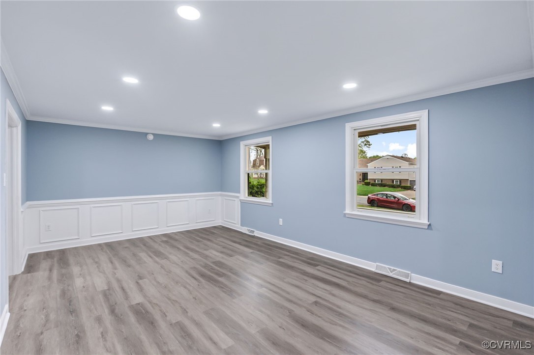 9232 Groomfield Road Chesterfield, VA 23236 - Photo 5 of 50 a view of an empty room with wooden floor and a window