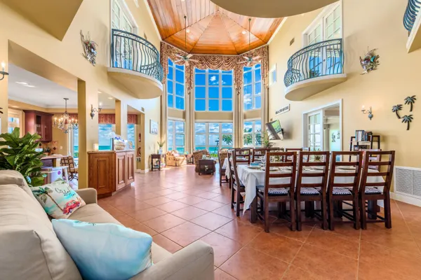 a view of a dining room with furniture a chandelier and wooden floor