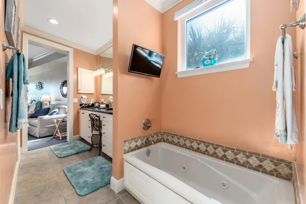 a bathroom with a tub sink and mirror