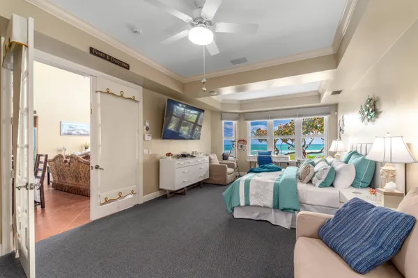 a bedroom with furniture and a flat screen tv