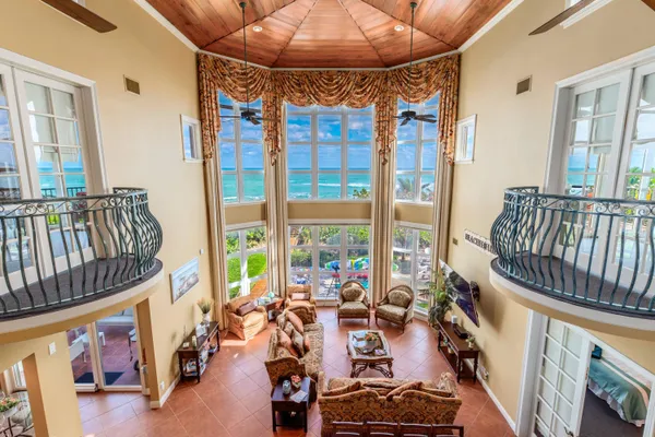 a dining room with furniture and a floor to ceiling window